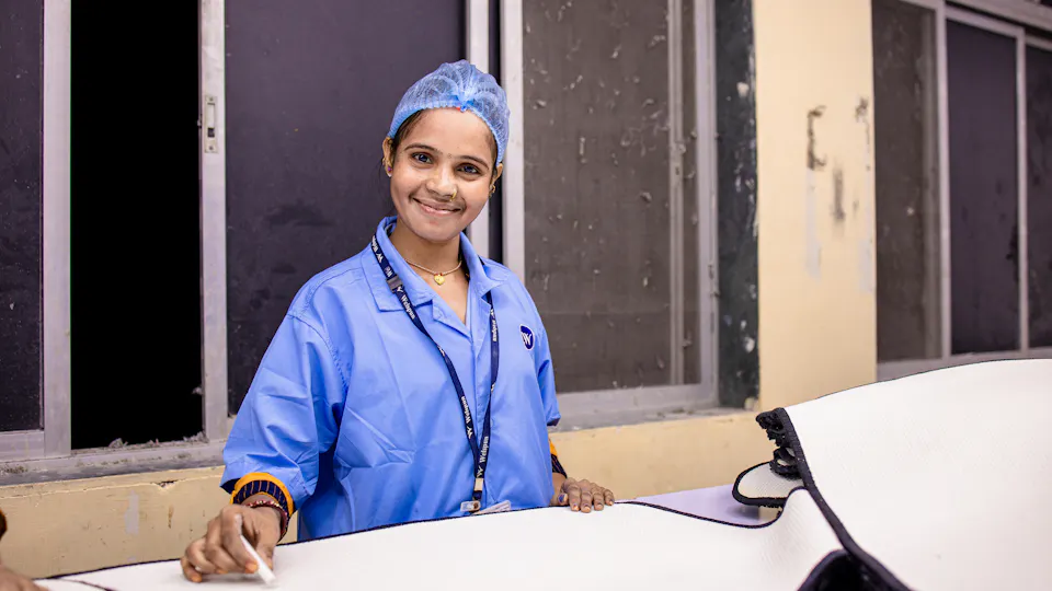 A smiling nurse in scrubs at a hospital