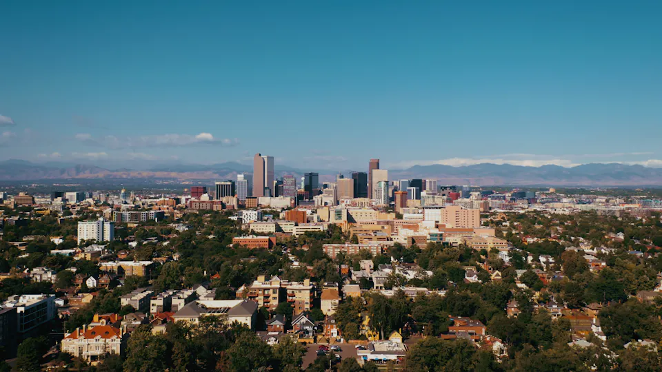 The Denver skyline with the Rocky Mountains behind it