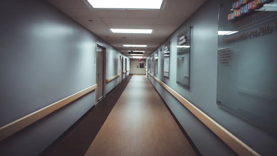 An empty hospital corridor lit at night